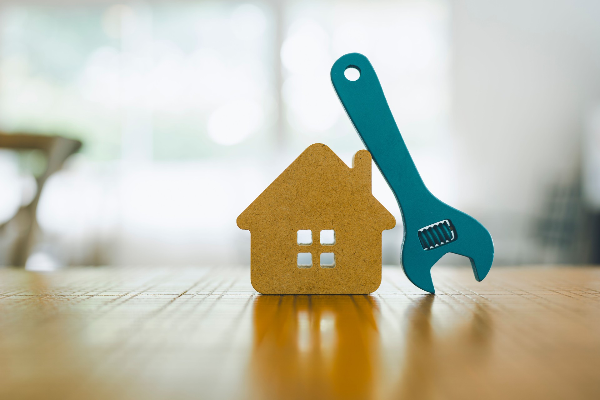 Model house and wrench, home services. Home repairs concept. Model house and wrench, home services. Home repairs concept.